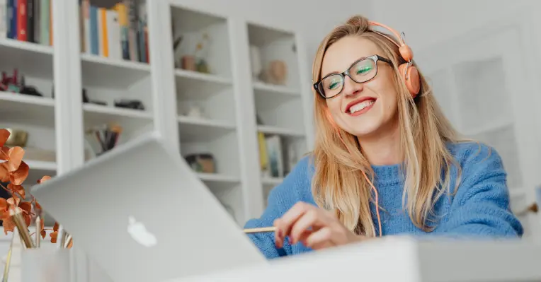 A Woman Smiling using Laptop