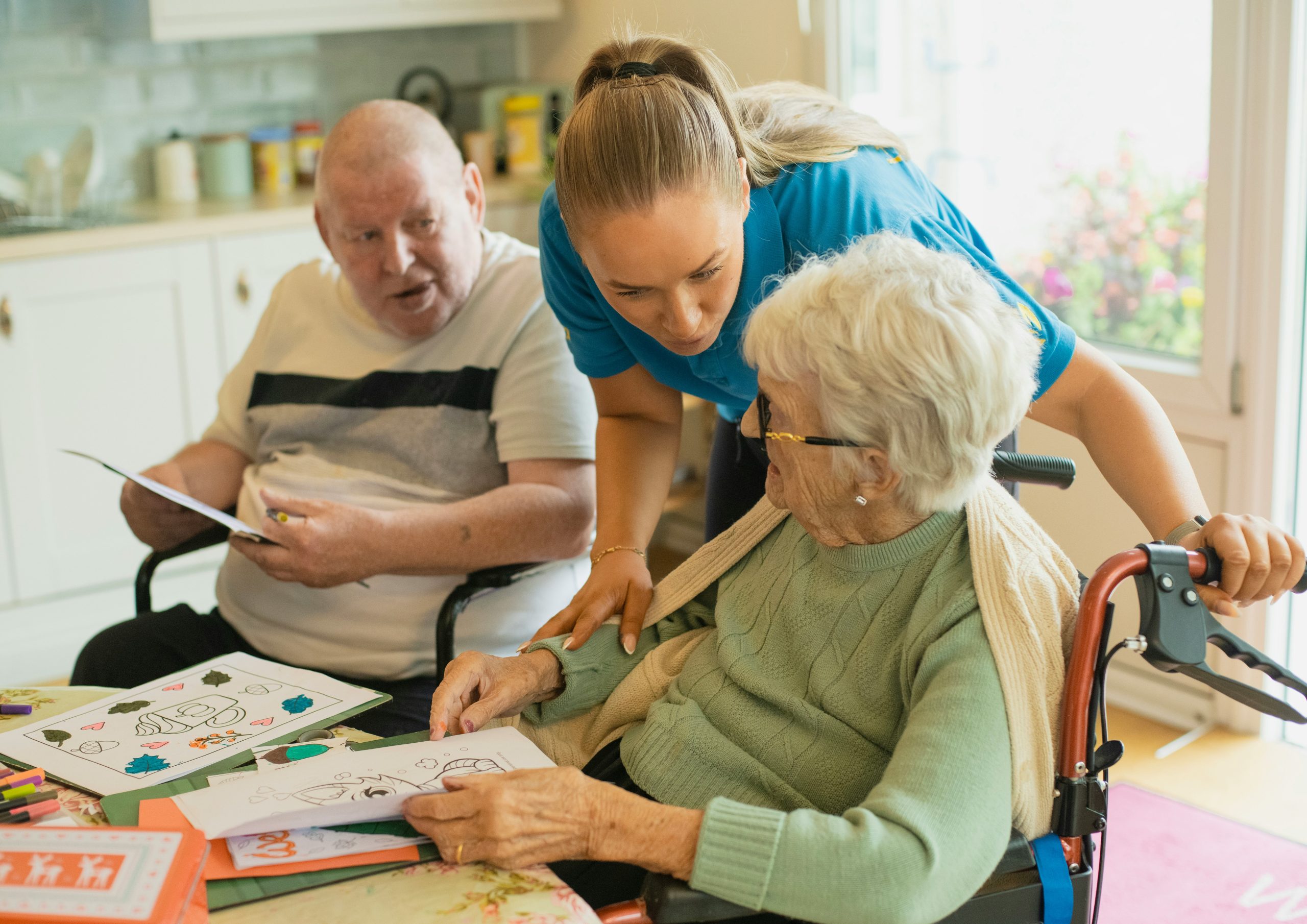 woman caring for elderly pair